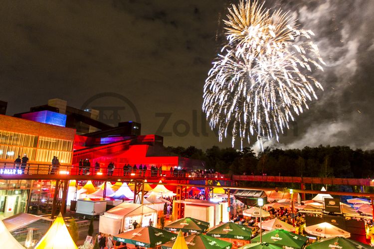 Einmal im Jahr treffen die regionalen Spitzengastronomen zur Gourmet-Meile Metropole Ruhr auf dem ehemaligen Gleisboulevard auf dem UNESCO-Welterbe Zollverein zusammen. Neben einer breiten Vielfalt kulinarischer Verlockungen bietet dieses Event ein anregendes und stimmungsvolles Ambiente für Gäste und Feinschmecker aus der ganzen Region.

Gleisboulevard nennt sich der Platz nördlich der Kohlenwäsche [A14] zwischen der Fritz-Schupp-Allee und der Halle 12 [A12]. Zu Betriebszeiten reihten sich dort die Waggons aneinander, die unter den Produktionsanlagen mit Kohle bzw. Bergematerial beladen wurden. 

Ort: Areal A [Schacht XII]

Das 55 Meter hohe Doppelbock-Fördergerüst ist das Wahrzeichen der Zeche Zollverein, der Stadt Essen und der gesamten Region: Die als Doppelstrebengerüst in Vollwandbauweise konstruierte Förderanlage ermöglichte eine doppelte Fördermechanik, mittels derer die doppelte Menge Förderwagen bzw. Fördergefäße transportiert werden konnten. Zollverein Schacht XII galt zu Betriebszeiten als die leistungsstärkste Zeche der Welt. 250 Stufen führen auf die oberste Plattform des Gerüstes, deren Seilscheiben sich auch heute noch drehen: Der Schacht wird heute von der RAG AG für die zentrale Wasserhaltung genutzt.

Pause machen im Bistro „Butterzeit!“ und Kunsthandwerk entdecken, wo früher Waggons mit Kohle beladen wurden: Die Ateliers im Erdgeschoss der Halle 12 [A12], darunter SchmuckProdukt und die ARKA Kulturwerkstatt, präsentieren neben eigenen Arbeiten auch wechselnde Ausstellungen anderer Künstler. Im Obergeschoss der ehemaligen Lesebandhalle finden heute Kongresse, Messen und Konzerte statt. Bis in die 1960er Jahre lasen hier Bergleute an fünf Lesebändern von Hand die großen Gesteinsstücke aus dem Rohkohlegemisch.

Der Wagenumlauf [A18] befindet sich zwischen der Wipperhalle und der Rückseite des Doppelbock-Fördergerüstes [A1]. In dem langgestreckten Gebäude wurden die Förderwagen, nachdem sie entleert wurden, wieder zurück zum Schacht geführt. Heute ist der Wagenumlauf Teil des Denkmalpfads ZOLLVEREIN®.

Das größte Übertagegebäude auf Zollverein, die Kohlenwäsche [A14], war zu Betriebszeiten eine Riesenmaschine, die täglich 23.000 Tonnen Rohkohle sortierte und klassierte. Von 2003 bis 2006 wurde sie von dem Office for Metropolitan Architecture (OMA) unter Leitung von Rem Koolhaas und dem Essener Büro Böll & Krabel umfassend saniert. Eine 58 Meter lange Rolltreppe bringt die Besucher heute direkt in das RUHR.VISITORCENTER Essen auf der 24-Meter-Ebene. Die Kohlenwäsche ist zentrale Anlaufstelle für Besucher sowie Museumsgebäude des 2010 eröffneten Ruhr Museums und des Portals der Industriekultur. Die oberen Etagen gehören mit den authentisch erhaltenen Übertageanlagen zum Denkmalpfad ZOLLVEREIN®. Auf dem Dach der Kohlenwäsche sind zwei Aussichtsplattformen installiert, die einen Rundblick auf das Gelände und die Region bieten.