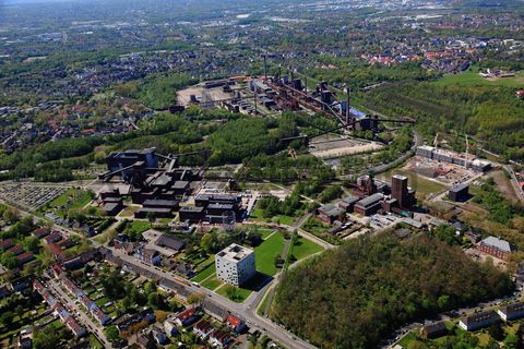 Die Zentralschachtanlage Zollverein XII wurde 1932 in Betrieb genommen und zählte bis zu ihrer Stilllegung 1986 zu den größten und leistungsstärksten Steinkohlenzechen weltweit. Das Meisterwerk der Bergbauarchitektur, geschaffen von den Visionären Fritz Schupp und Martin Kremmer, galt von Beginn an als „schönste Zeche der Welt“. 

Areal A [Schacht XII]

Die Gründungsschachtanlage 1/2/8 war von 1851 bis 1986 in Betrieb und beherbergte u. a. die Sozialräume der Bergleute. Sie wurde im Stil des Historismus errichtet und spiegelt die Hauptepoche des Steinkohlebergbaus im Ruhrgebiet wider. 

Areal B [Schacht 1/2/8]

Die Kokerei Zollverein wurde von 1957 bis 1961 errichtet. Nach einer Erweiterung war die Anlage seit 1973 bis zur Stilllegung 1993 die größte Zentralkokerei Europas.

Areal C [Kokerei]