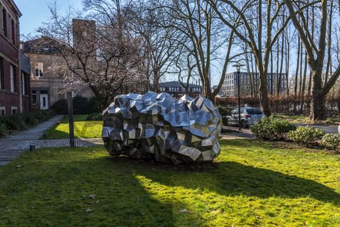 Die Sonne bringt den 590 Kilo schweren „Asteroid PF751ZH“ vor dem Verwaltungsgebäude der Stiftung Zollverein zum Glänzen. Seit 2019 liegt dort die zwei Meter hohe und drei Meter breite Skulptur des Stahlbildhauers HEX. Die Skulptur gehört zu einer Reihe von Asteroid-Skulpturen des Künstlers und entstand 2017.